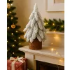 Brad de Crăciun artificial decorativ pe un trunchi acoperit de zăpadă 20 x 9 cm